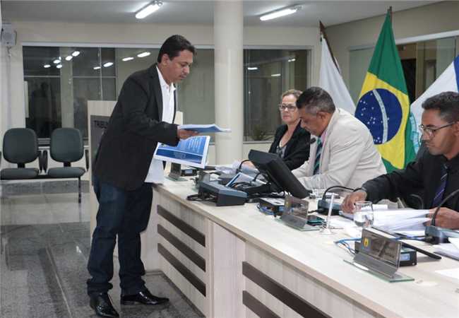 Relator protocola relatório da CPI da COPASA durante reunião da Câmara de Nova Serrana.